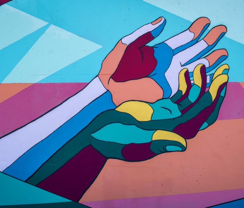 Hands stretched out colored in different colors - GCF encyclical